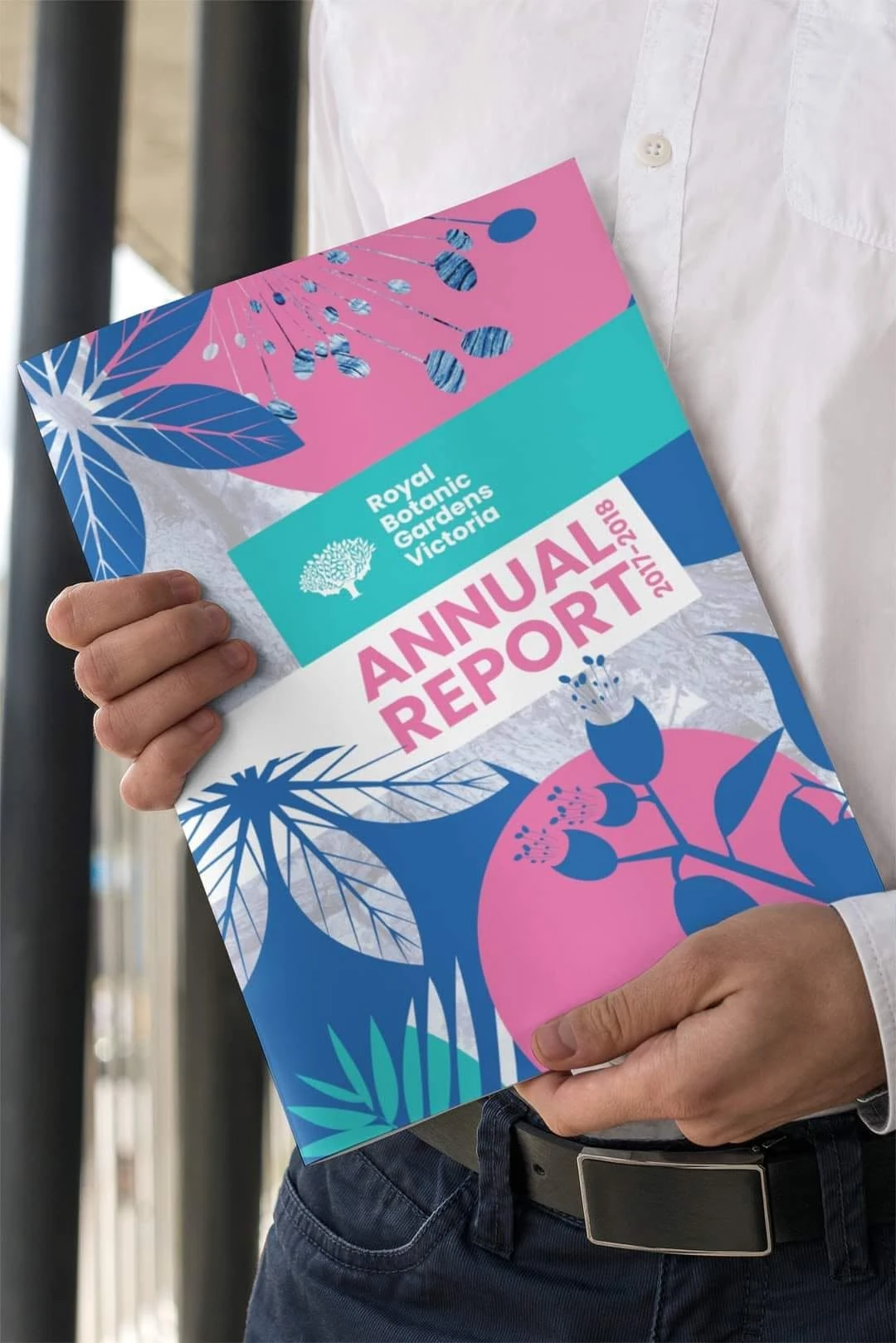 Royal Botanic Gardens Victoria annual report held in hand