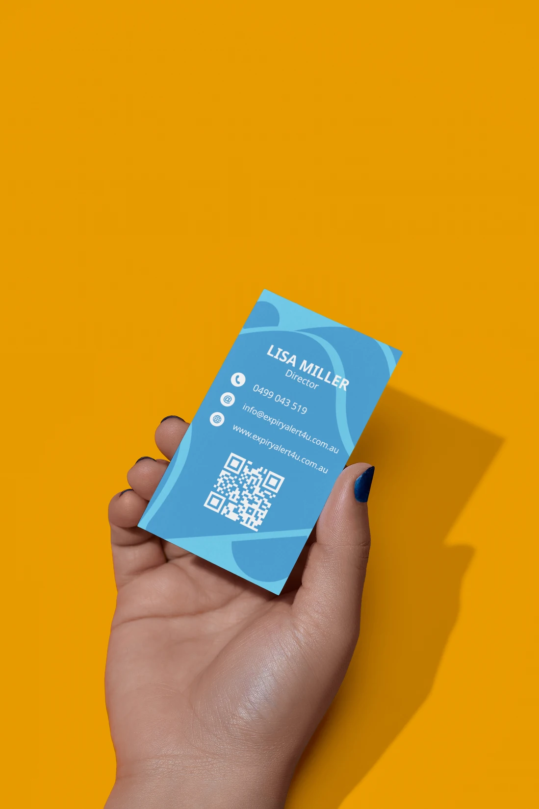 Back of the Expire Alert 4U business card held against an orange background