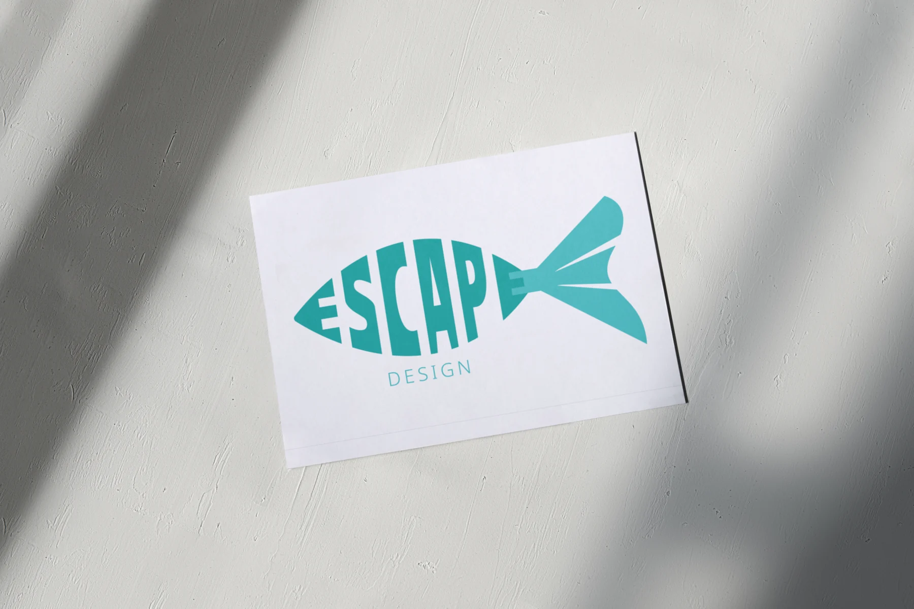 Escape Design business card featuring the custom fish-shaped logo