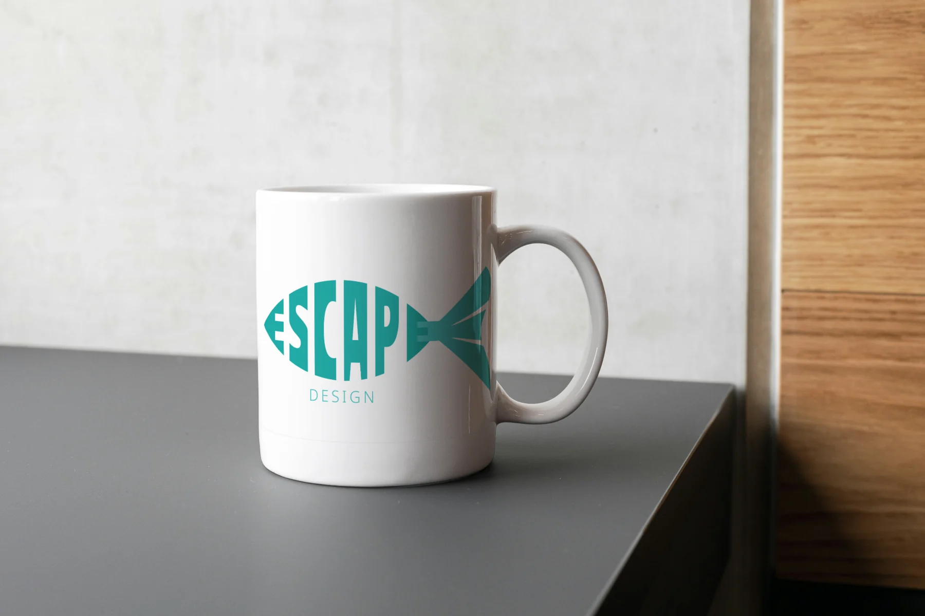 Escape Design fish logo applied to a white mug